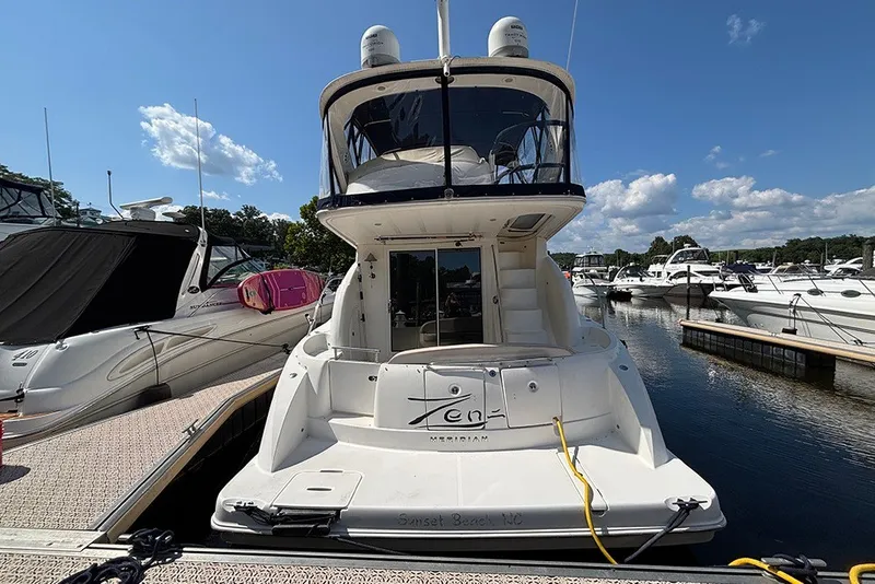 Slide: The Image of 2009 Meridian 391 Sedan yacht docked at marina under clear blue sky. - 3