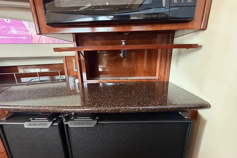 Slide: The Image of 2009 Meridian 391 Sedan kitchen area with convection grill and storage cabinets. - 18