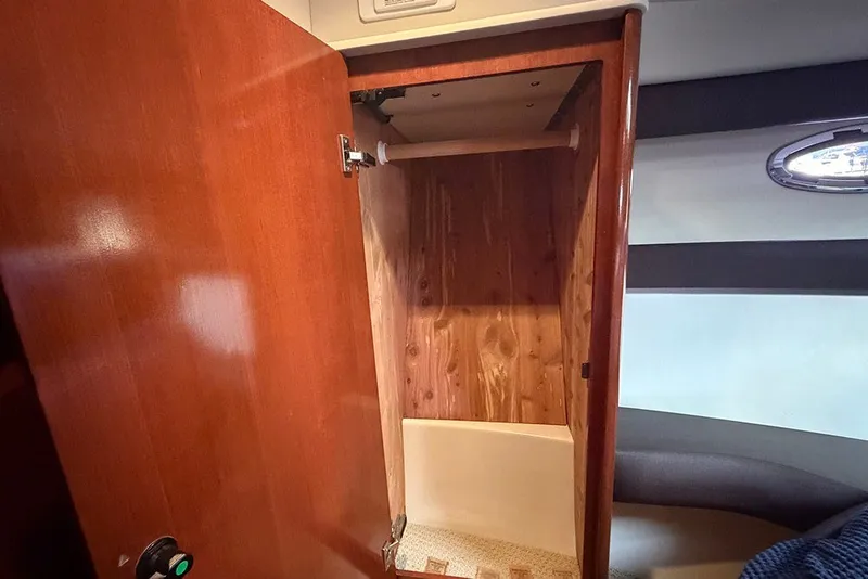 Slide: The Image of Open wooden closet inside 2009 Meridian 391 Sedan yacht cabin. - 23
