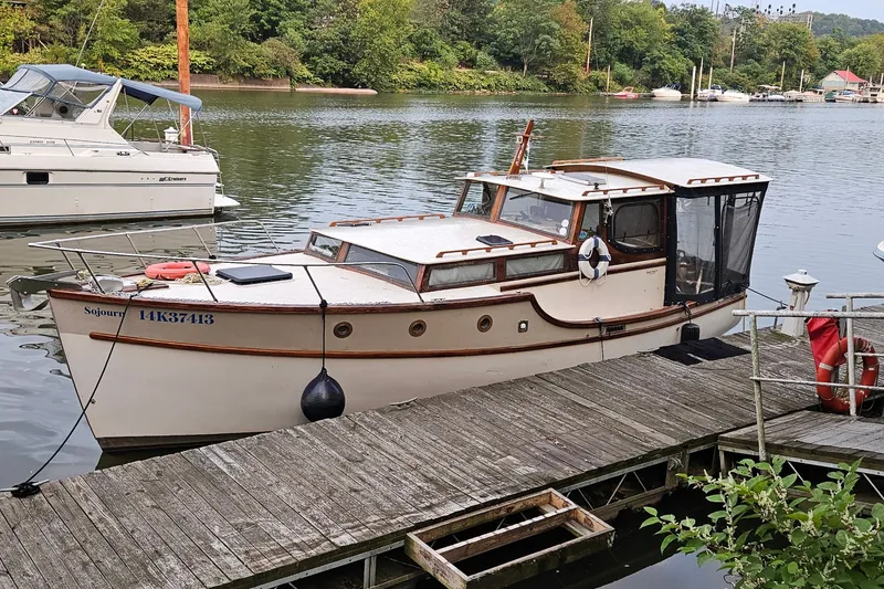 The Image of Classic 1995 Maple Bay 27 boat docked on a serene lake. - 1