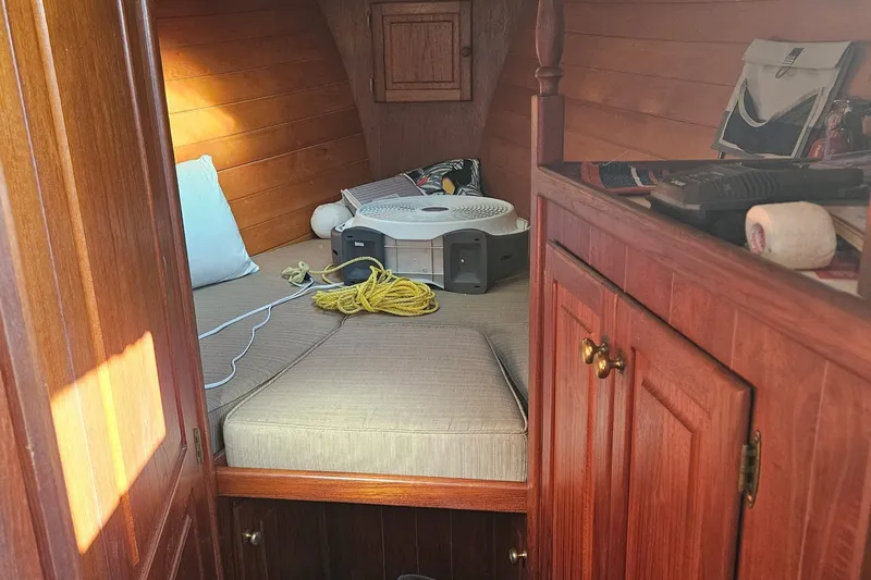 Slide: The Image of Cozy cabin interior of 1995 Maple Bay 27 boat with wooden finish and fan. - 5