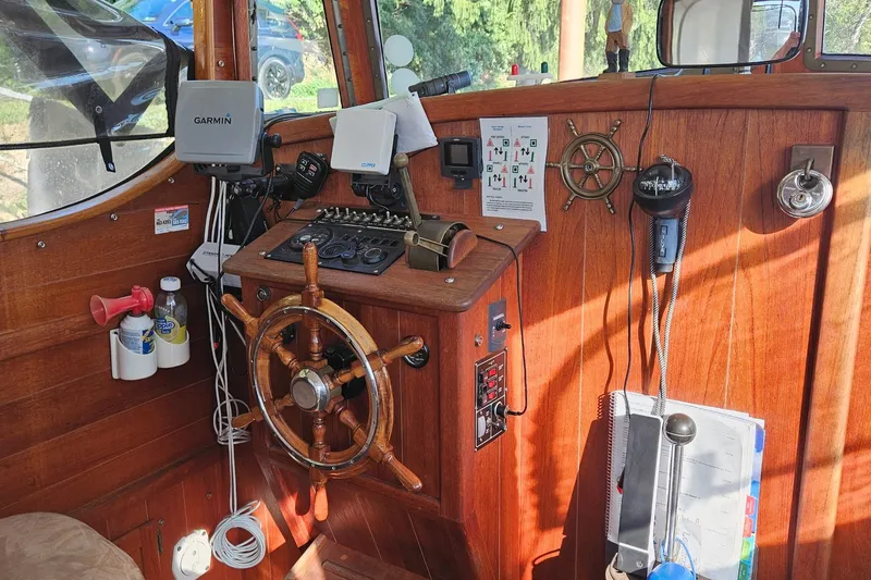 Slide: The Image of Interior of a 1995 Maple Bay 27 boat with wooden helm and navigation equipment. - 2