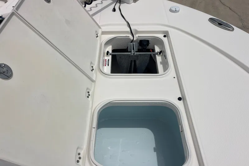 Slide: The Image of Open storage compartments on a 2019 Robalo 246 Cayman boat deck. - 27