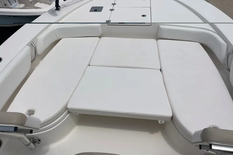 Slide: The Image of 2019 Robalo 246 Cayman boat with spacious white seating area. - 30
