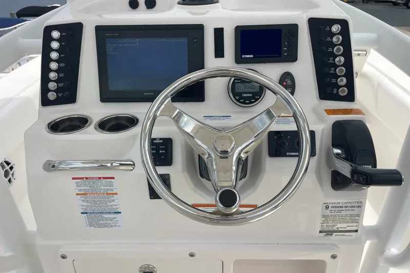 Slide: The Image of Control panel of a 2019 Robalo 246 Cayman boat with steering wheel and navigation displays. - 24