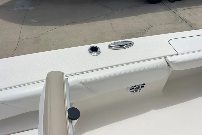 Slide: The Image of 2019 Robalo 246 Cayman boat interior with white seating and speaker. - 34