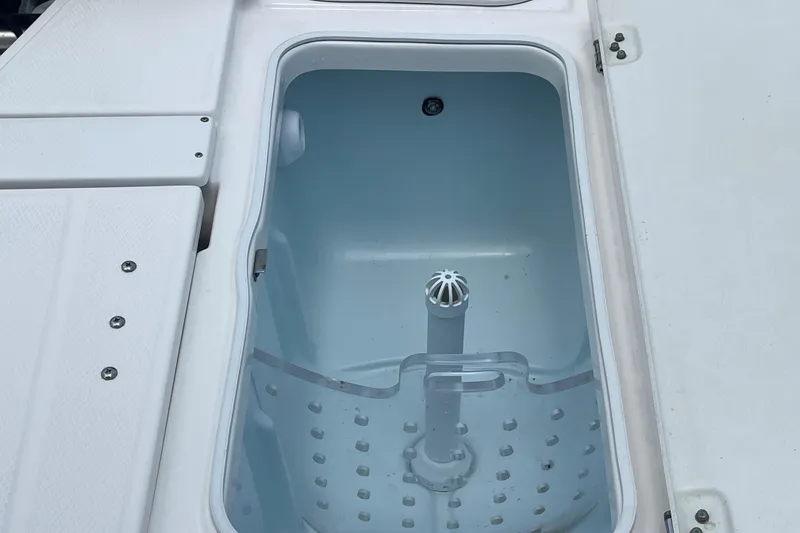 Slide: The Image of Livewell compartment on a 2019 Robalo 246 Cayman boat, featuring a clean interior. - 14