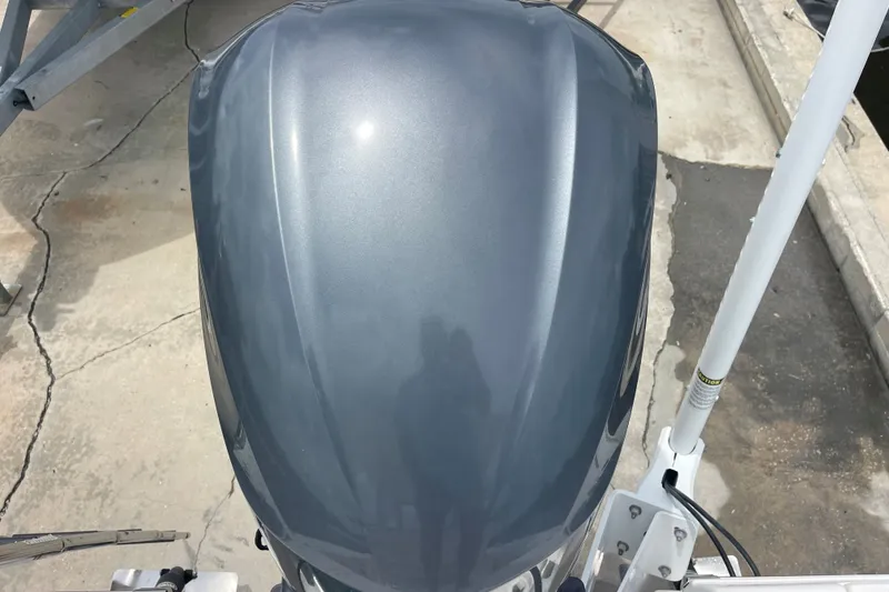 Slide: The Image of Top view of a 2019 Robalo 246 Cayman boat engine cover, showcasing sleek design. - 22