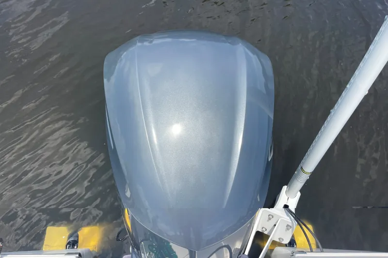 Slide: The Image of Overhead view of a 2019 Robalo 246 Cayman boat engine on water. - 15