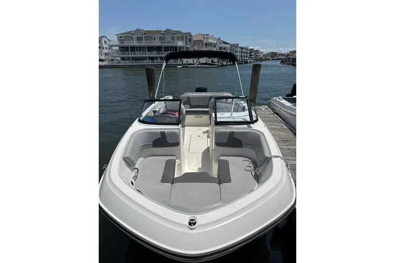 The Image of 2023 Bayliner VR6 Bowrider OB docked, showcasing spacious seating and sleek design. - 0