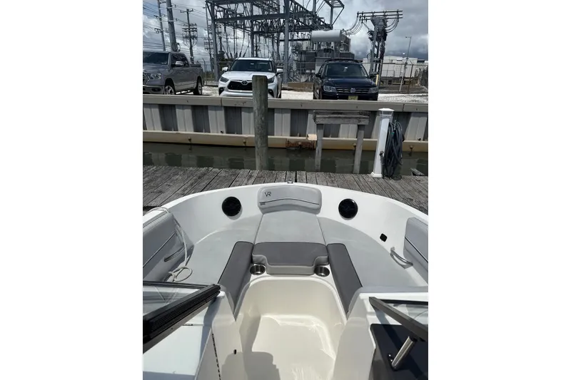 Slide: The Image of 2023 Bayliner VR6 Bowrider OB at dock, featuring spacious seating and modern design. - 6