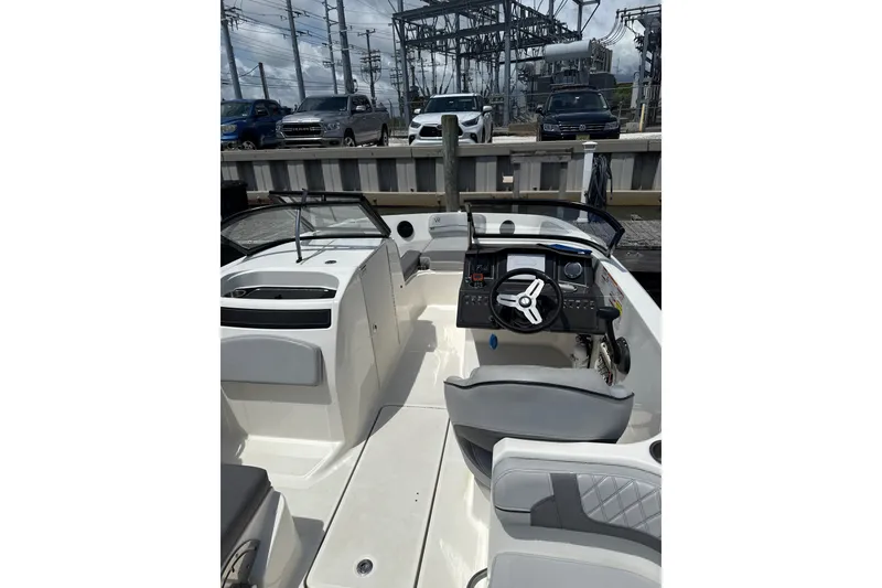 Slide: The Image of 2023 Bayliner VR6 Bowrider OB interior with steering wheel and seating. - 3