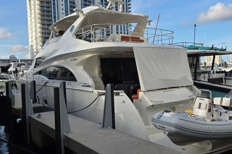 The Image of Luxury 2008 Marquis Fly 60 yacht docked at marina with inflatable boat. - 1
