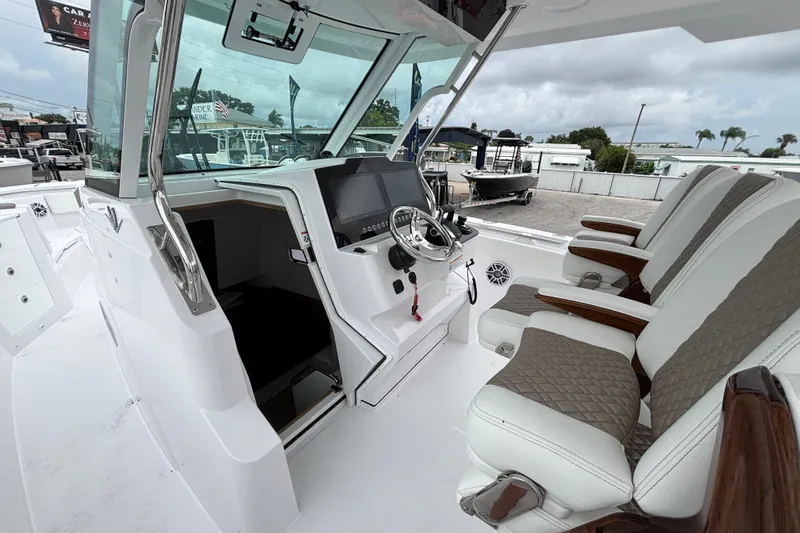 Slide: The Image of 2027 Bertram 34 CC boat cockpit with modern controls and luxurious seating. - 6