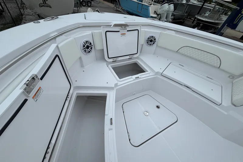 Slide: The Image of 2027 Bertram 34 CC boat interior with open storage compartments and speakers. - 12
