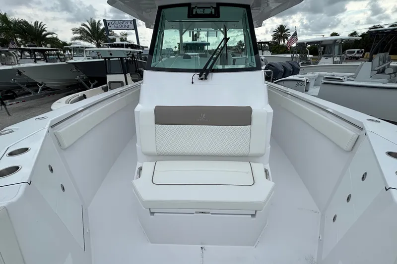 Slide: The Image of 2027 Bertram 34 CC boat interior with cushioned seating and modern design. - 13