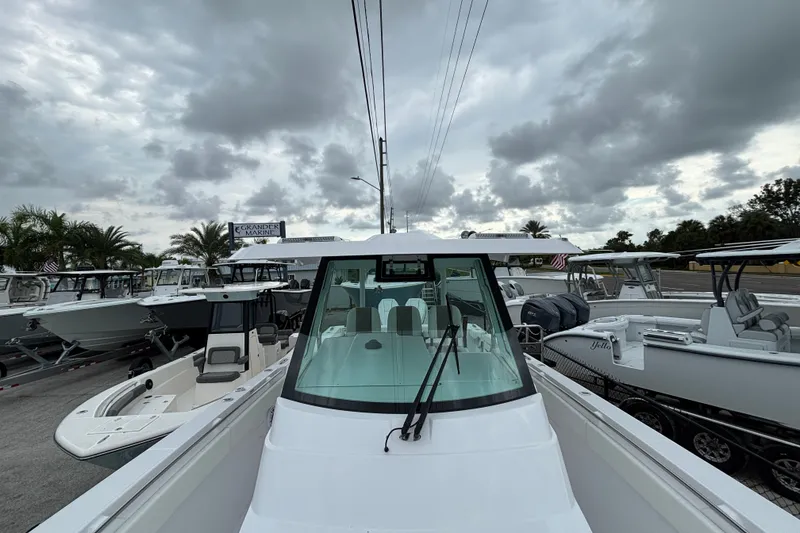 Slide: The Image of 2027 Bertram 34 CC boat at marina under cloudy sky. - 8