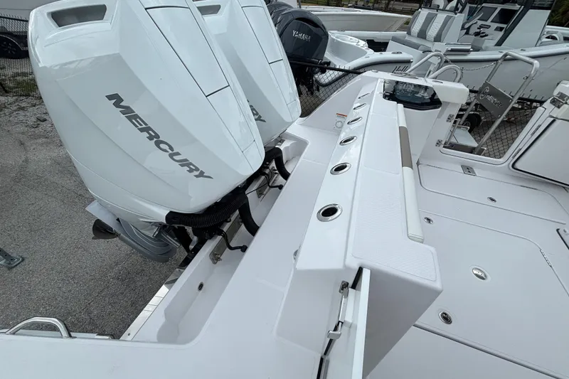 Slide: The Image of 2027 Bertram 34 CC boat with dual Mercury outboard engines, showcasing sleek design and spacious deck. - 19
