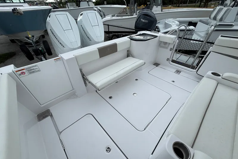 Slide: The Image of 2027 Bertram 34 CC boat interior with seating and Mercury engines. - 15
