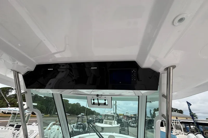 Slide: The Image of 2027 Bertram 34 CC boat interior with modern dashboard and navigation equipment. - 5