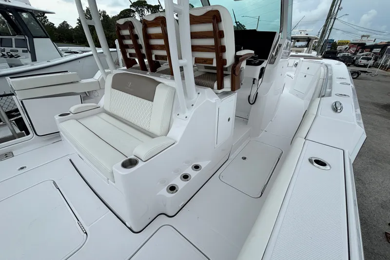 Slide: The Image of 2027 Bertram 34 CC boat interior with white seating and rod holders. - 16