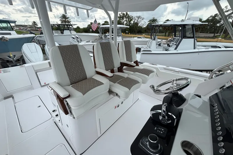 Slide: The Image of 2027 Bertram 34 CC boat interior with luxury seating and modern helm controls. - 24