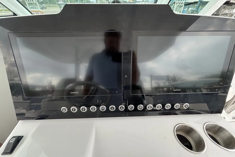 Slide: The Image of Dashboard of 2027 Bertram 34 CC boat with dual Garmin displays and control buttons. - 7