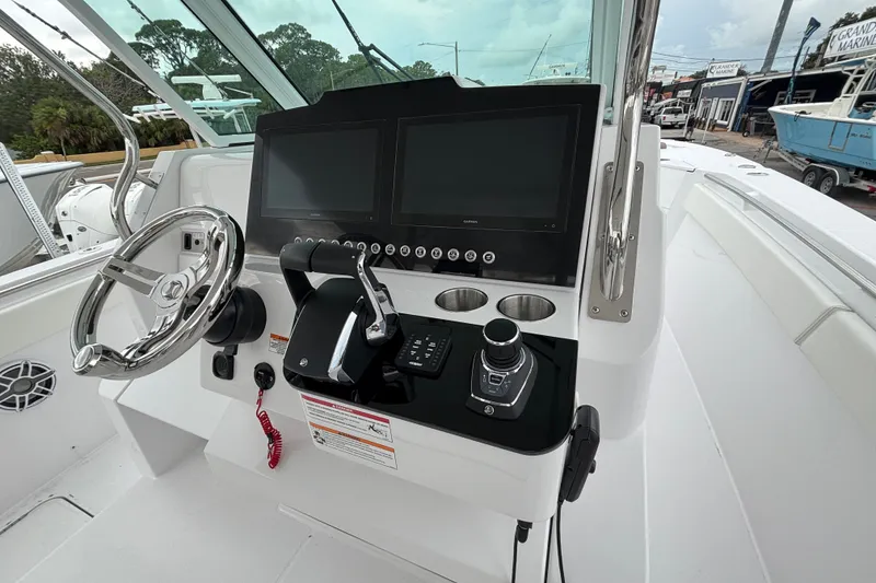 Slide: The Image of 2027 Bertram 34 CC boat cockpit with modern controls and dual screens. - 17