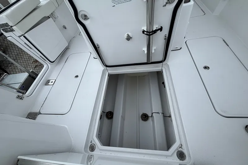 Slide: The Image of 2027 Bertram 34 CC boat deck with open storage compartments. - 23