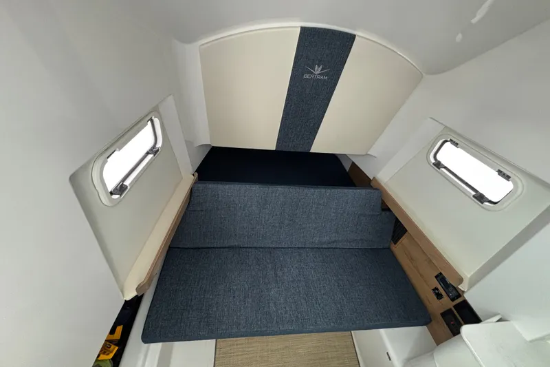Slide: The Image of Interior cabin of 2027 Bertram 34 CC boat with blue seating and windows. - 9