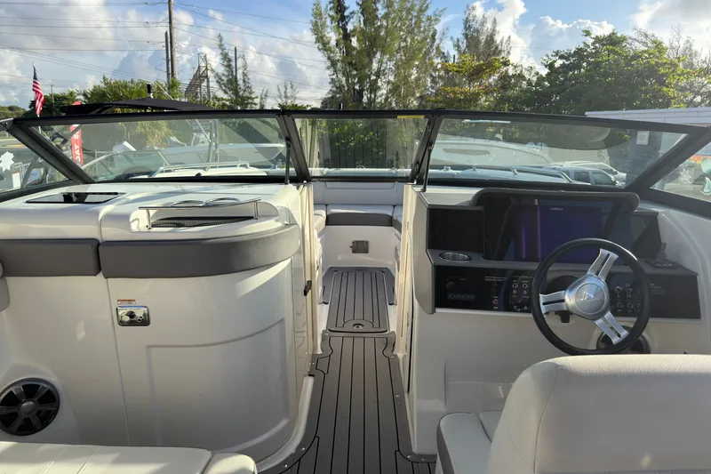 Slide: The Image of Interior view of 2021 Sea Ray SDX 270 boat, featuring sleek dashboard and steering wheel. - 9