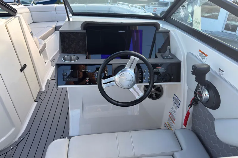 Slide: The Image of 2021 Sea Ray SDX 270 boat cockpit with steering wheel and control panel. - 7
