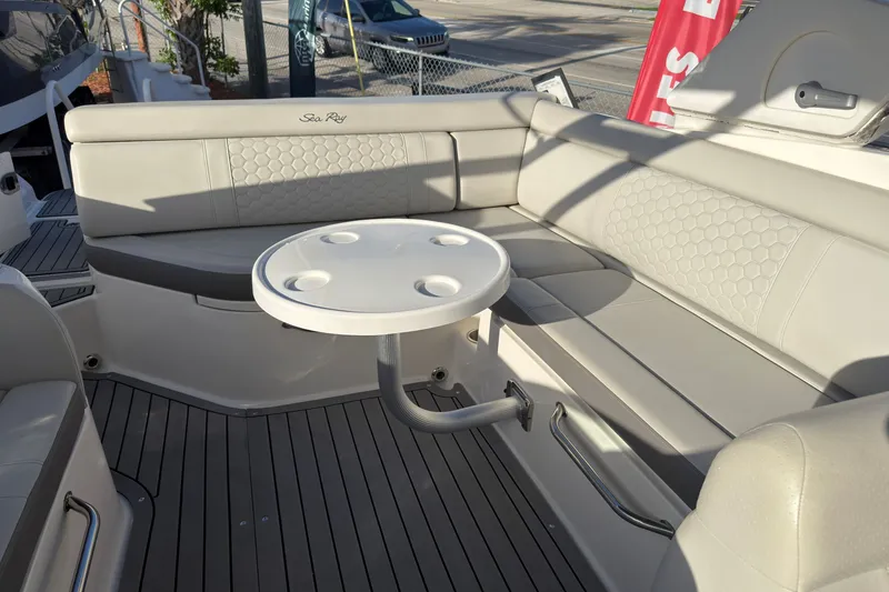 Slide: The Image of 2021 Sea Ray SDX 270 boat interior with beige seating and round table. - 5