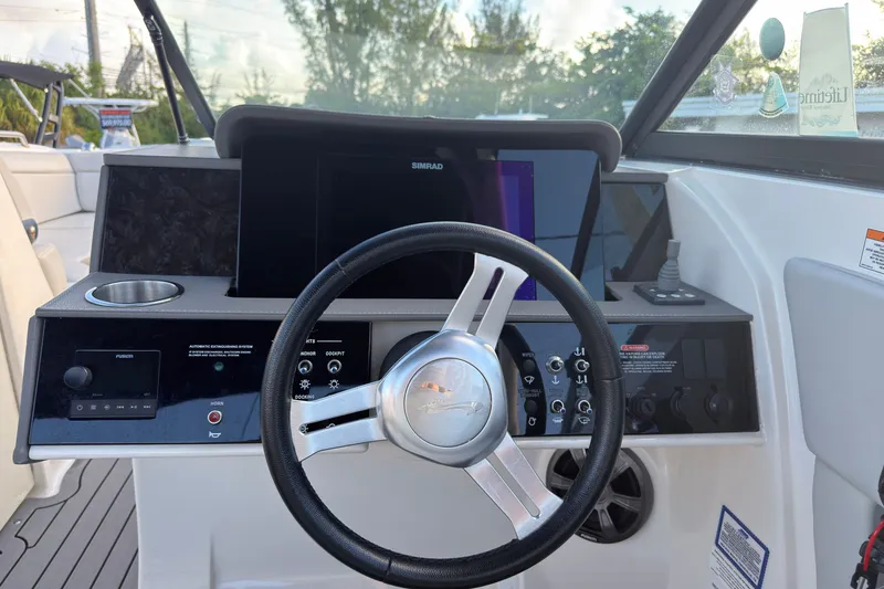 Slide: The Image of Steering console of a 2021 Sea Ray SDX 270 boat with modern controls and display. - 8