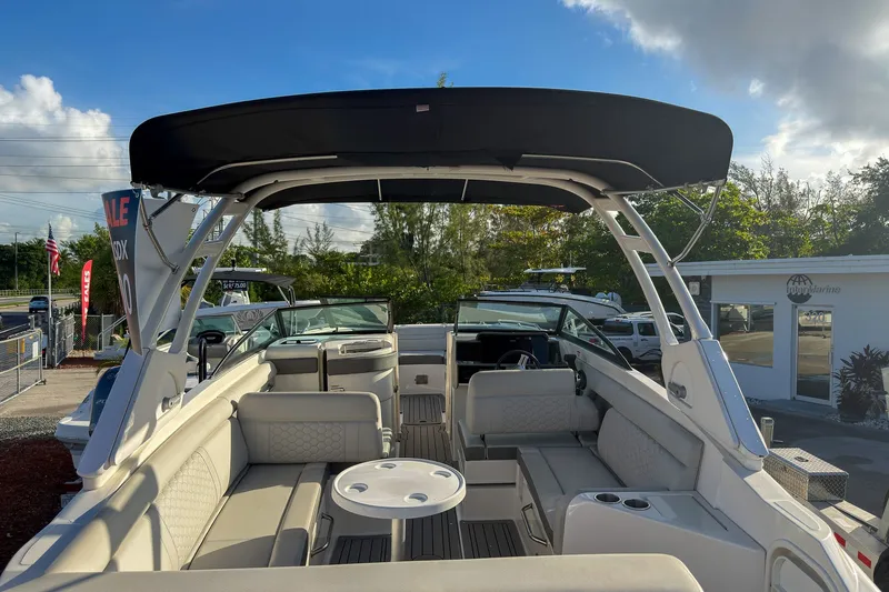 Slide: The Image of 2021 Sea Ray SDX 270 boat interior with seating and canopy, displayed outdoors. - 16