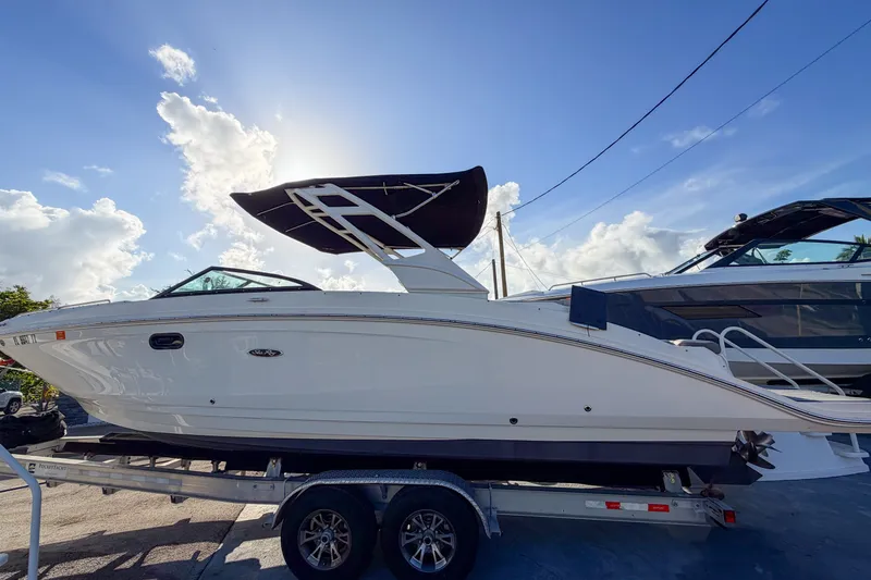 The Image of 2021 Sea Ray SDX 270 boat on trailer under clear blue sky. - 0
