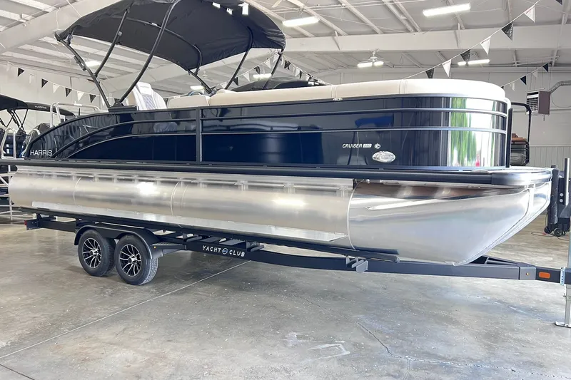 Slide: The Image of 2026 Harris Cruiser 250 pontoon boat on trailer in showroom. - 5
