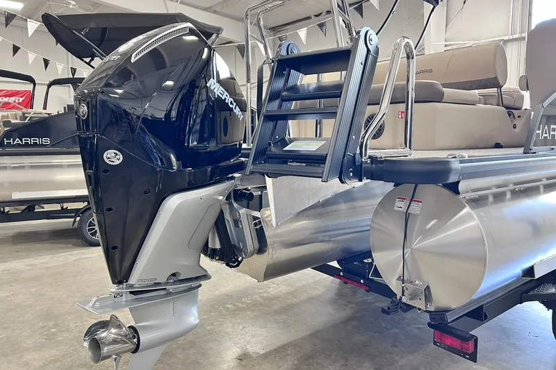 Slide: The Image of 2026 Harris Cruiser 250 pontoon boat with Mercury outboard motor in showroom. - 34