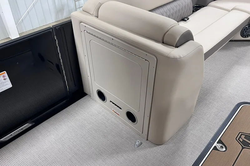 Slide: The Image of 2026 Harris Cruiser 250 interior with beige seating and storage compartment. - 28