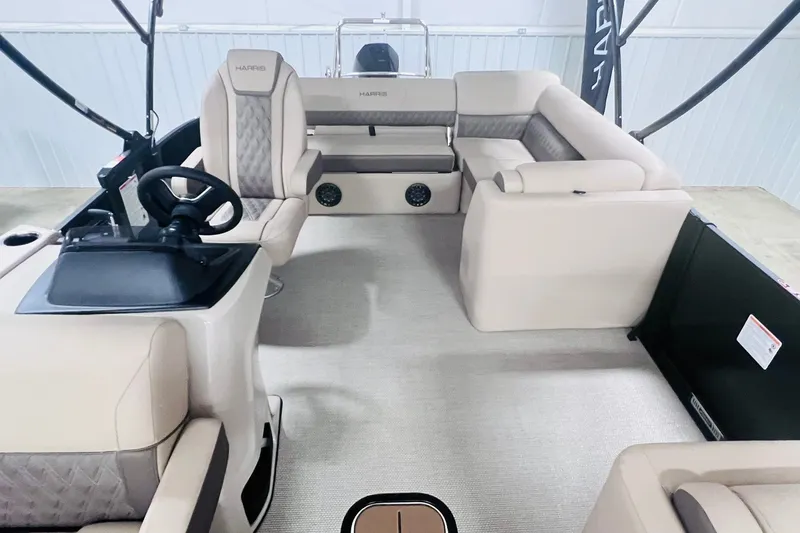 Slide: The Image of 2026 Harris Cruiser 250 boat interior with beige seating and steering console. - 7