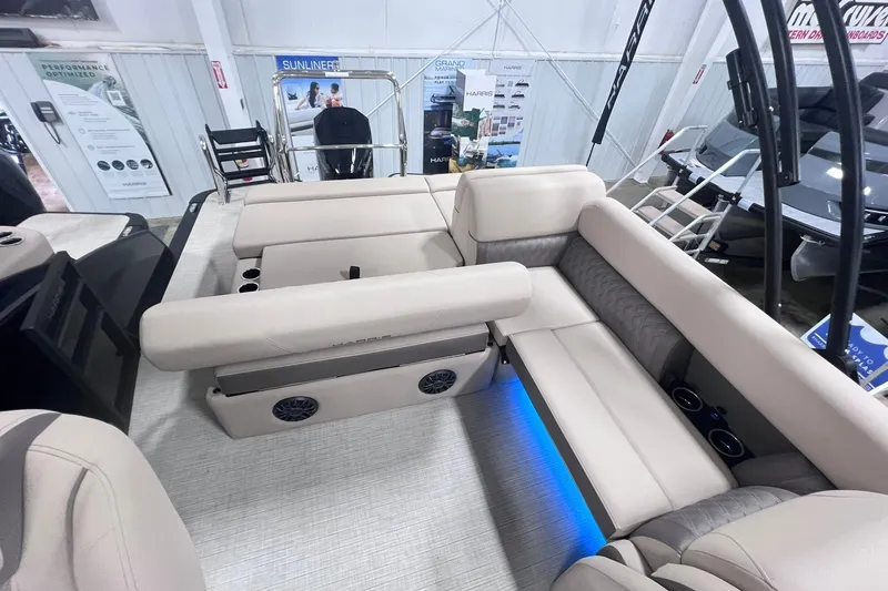 Slide: The Image of 2026 Harris Cruiser 250 interior with beige seating, blue LED lighting, and modern design. - 26
