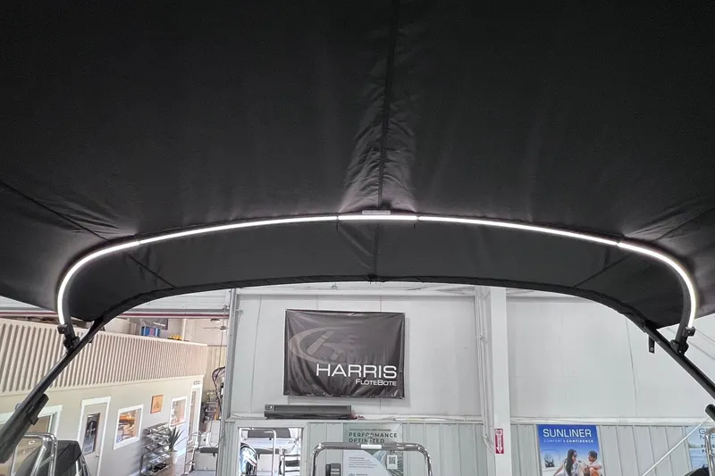 Slide: The Image of 2026 Harris Cruiser 250 boat canopy with LED lighting in showroom. - 9