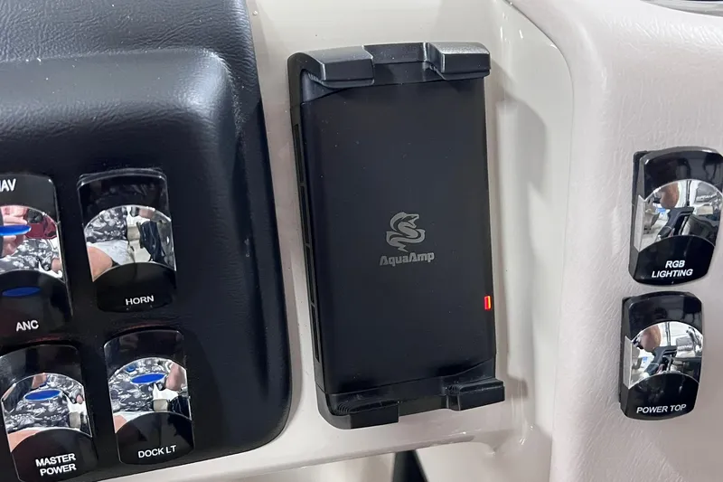 Slide: The Image of Control panel of 2026 Harris Cruiser 250 with AquaAmp device and various switches. - 18
