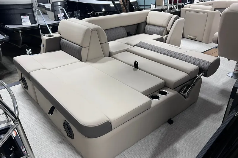 Slide: The Image of 2026 Harris Cruiser 250 boat interior with beige seating and cup holders. - 30