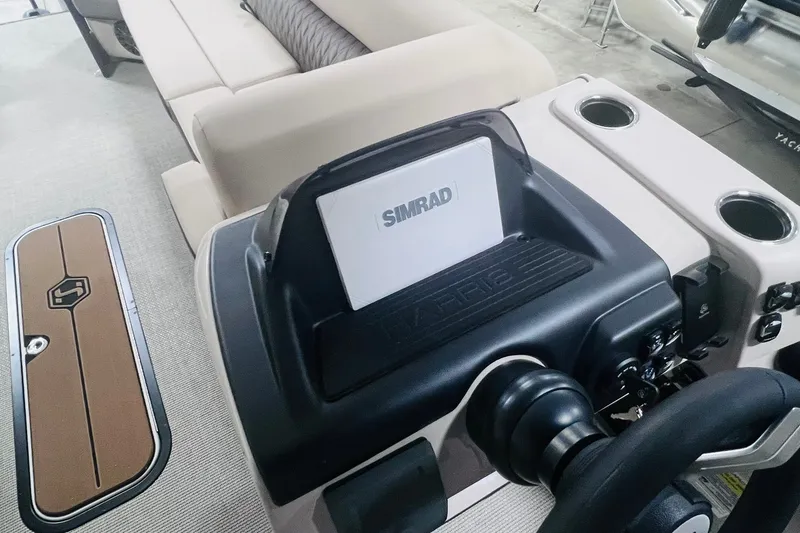 Slide: The Image of 2026 Harris Cruiser 250 boat interior with Simrad navigation system and comfortable seating. - 16