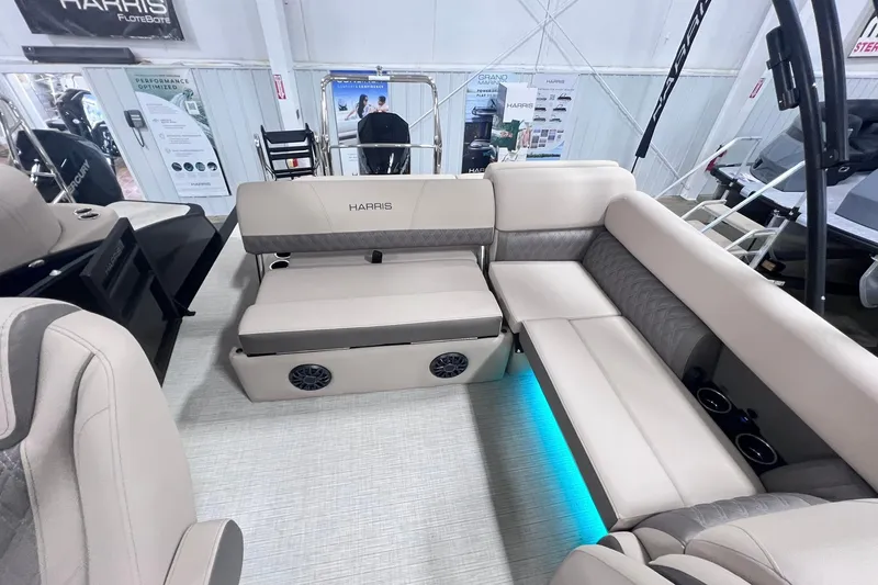 Slide: The Image of 2026 Harris Cruiser 250 interior with plush seating and ambient lighting. - 25