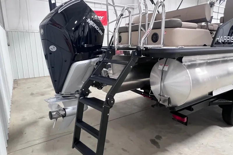 Slide: The Image of 2026 Harris Cruiser 250 pontoon boat with Mercury outboard motor and boarding ladder. - 41