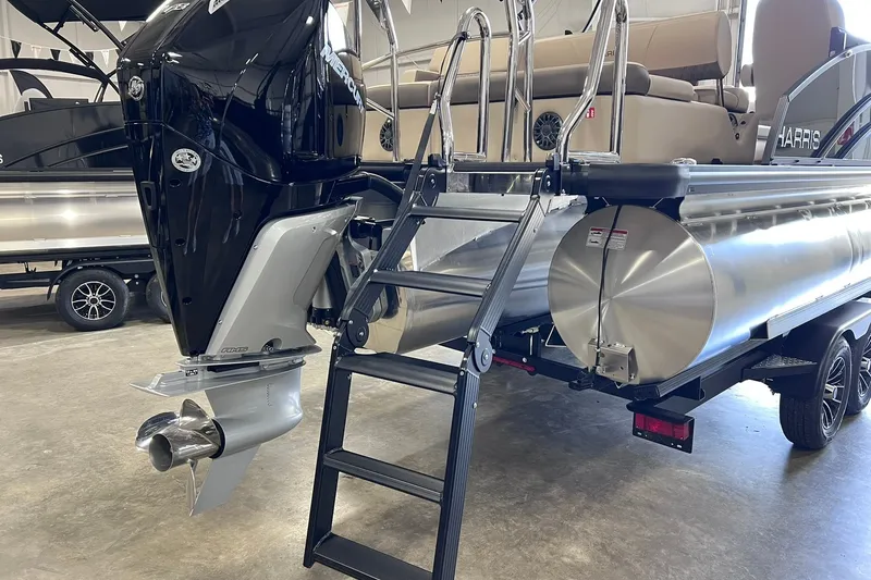 Slide: The Image of 2026 Harris Cruiser 250 pontoon boat with Mercury outboard motor and boarding ladder. - 35
