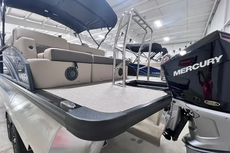 Slide: The Image of 2026 Harris Cruiser 250 pontoon boat with Mercury engine in showroom. - 42