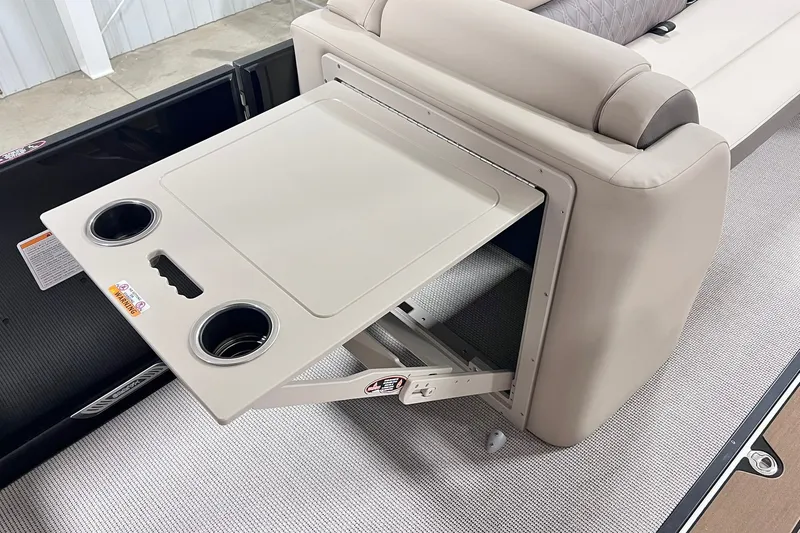Slide: The Image of 2026 Harris Cruiser 250 boat with retractable table and cup holders. - 29